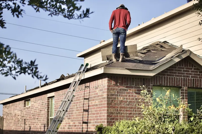 Professional roofer working on a residential roof in Old Mouth North River